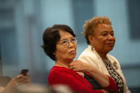 President Ching Wang and Oakland Mayor Barbara Lee sitting together watching panel