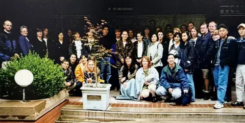 Group photo of PT students in front of a Japanese maple tree