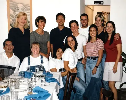 Students group photo around dinner table