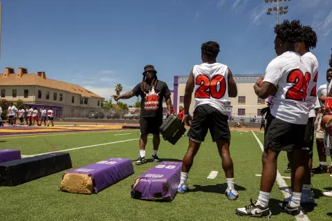 Marshawn Lynch coaching young athletes at football camp