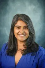 Headshot of woman in blue dress