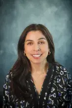 Woman wearing dark floral print shirt