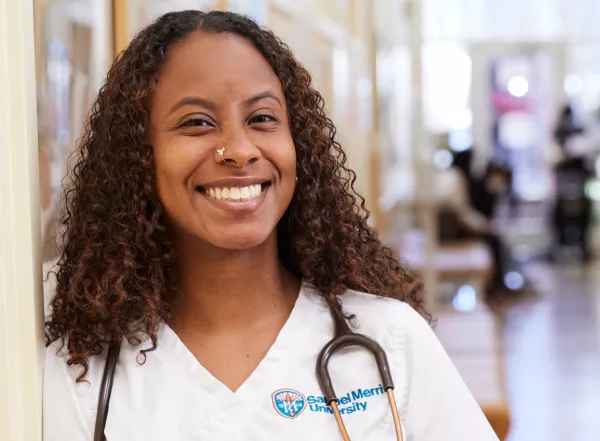 Smiling student standing in hallway of clinic