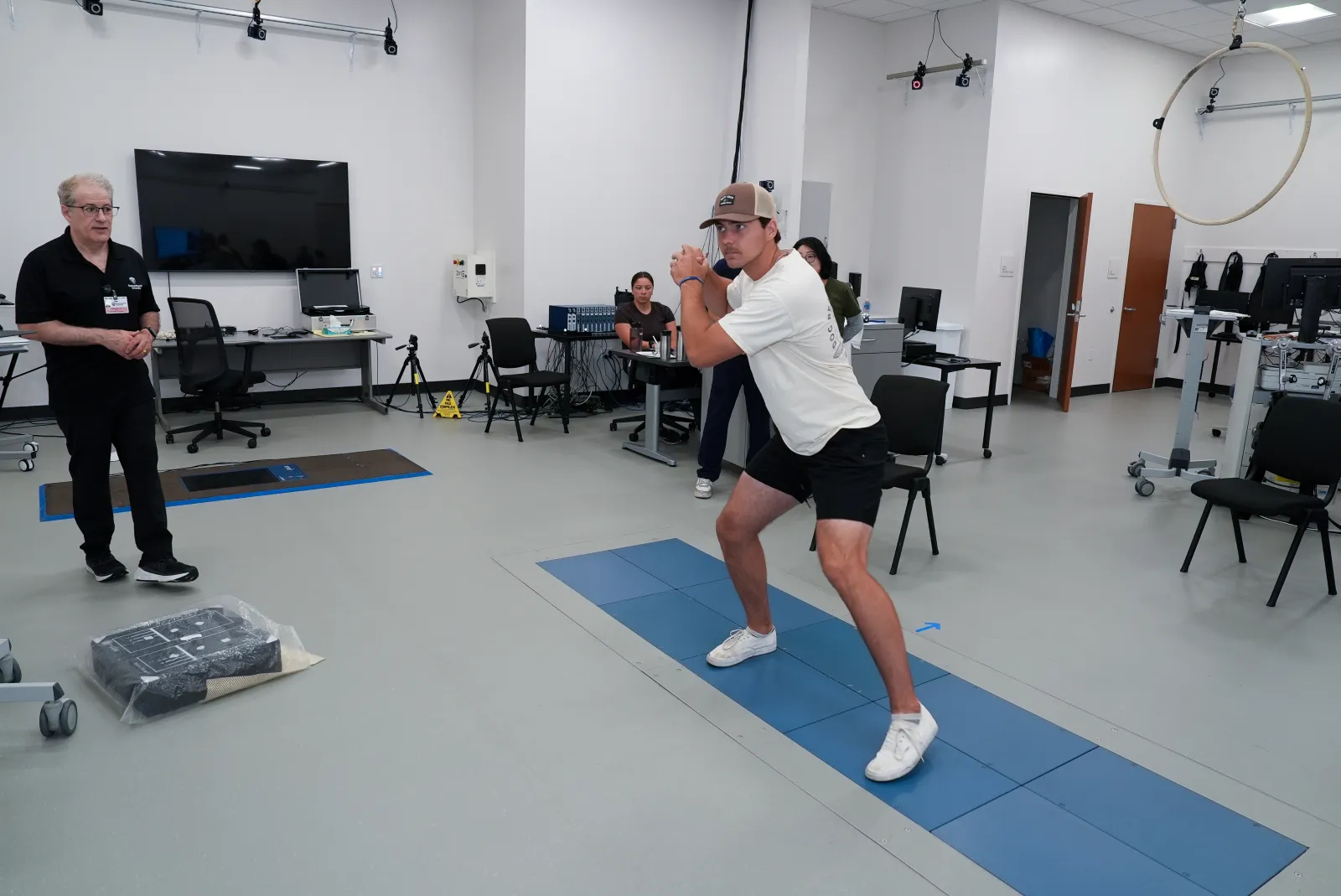 Student in baseball swing pose in center