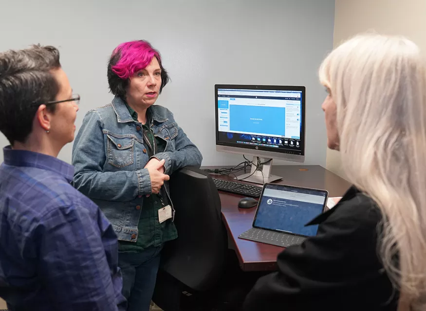 Instructors gathered around a computer