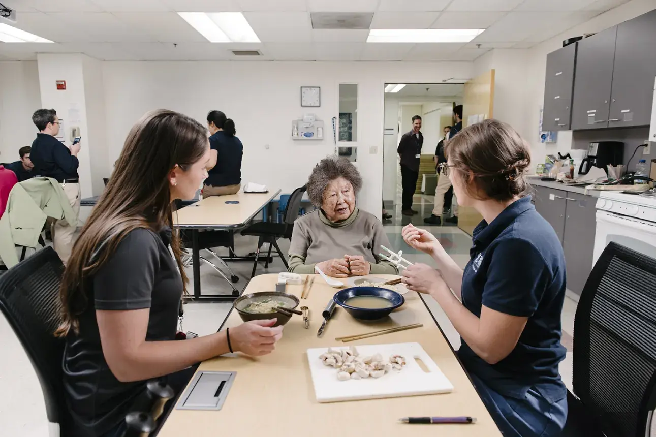 Occupational Therapy students working with a patient