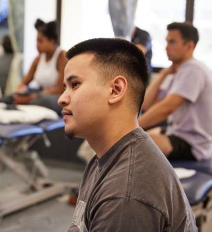 Physical therapy student listening in class