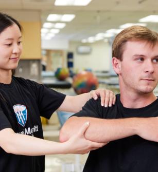 Student practicing physical therapy on a patient
