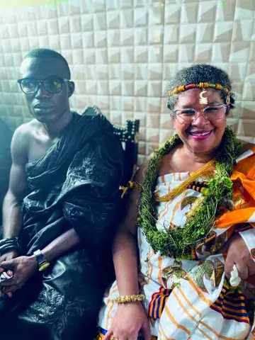 Carmen Ward-Sullivan and King Katakyie Agyemang Duah III dressed in traditional African clothing.