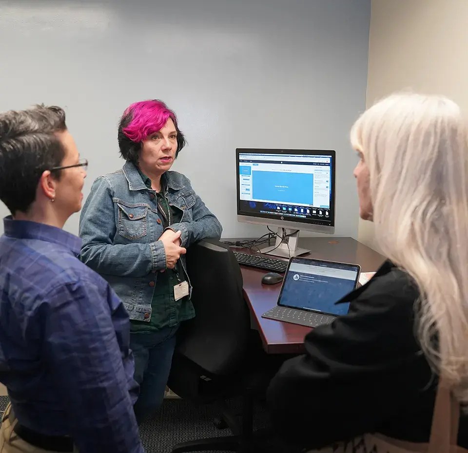 Instructors gathered around a computer