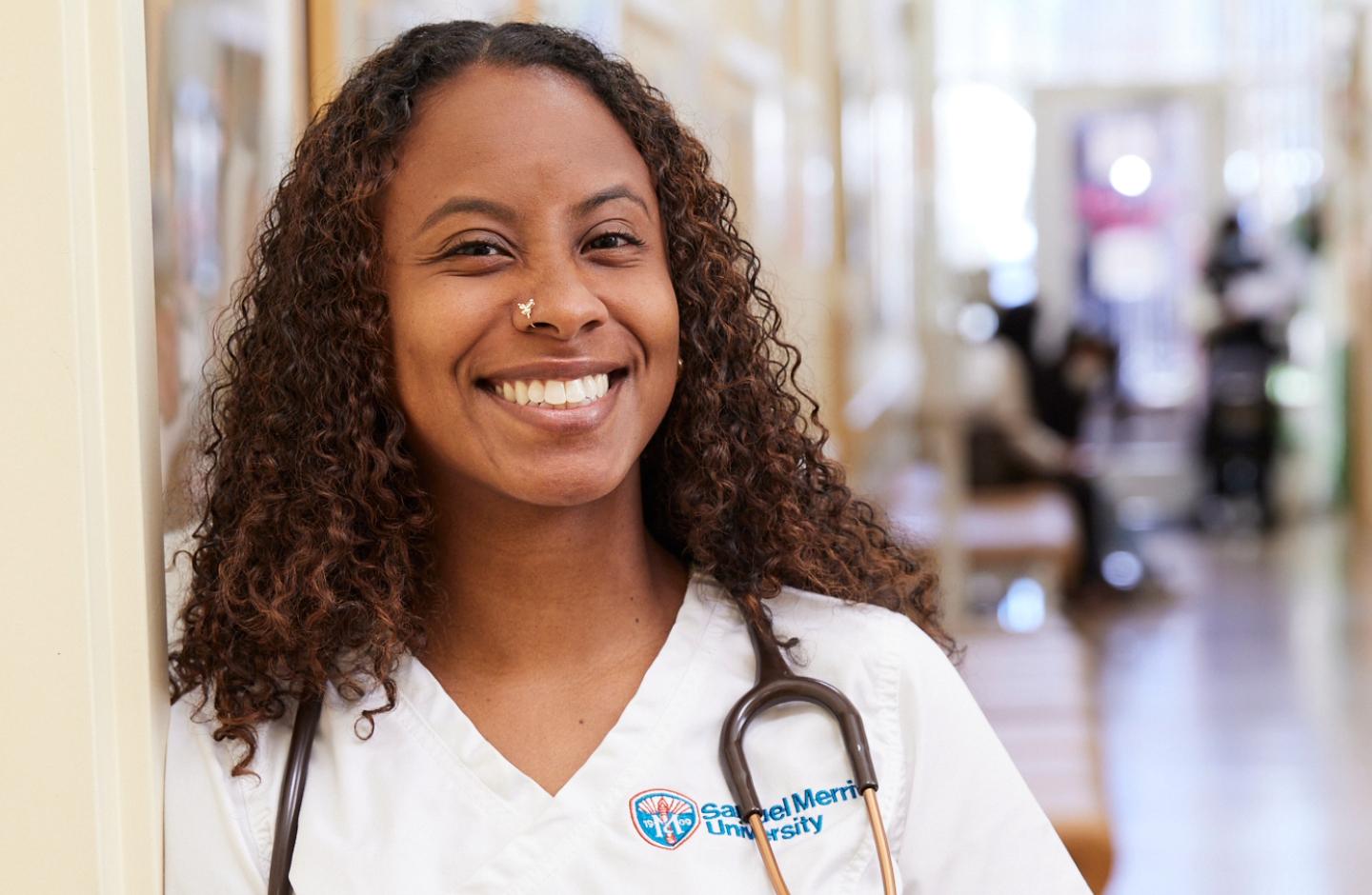 Smiling student standing in hallway of clinic