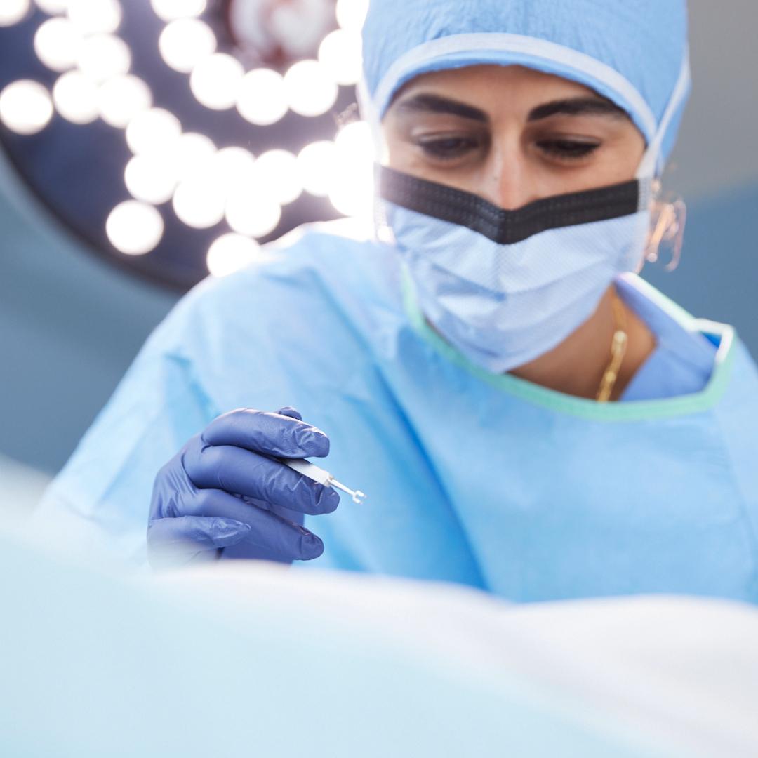 Surgeon with scalpel in operating room
