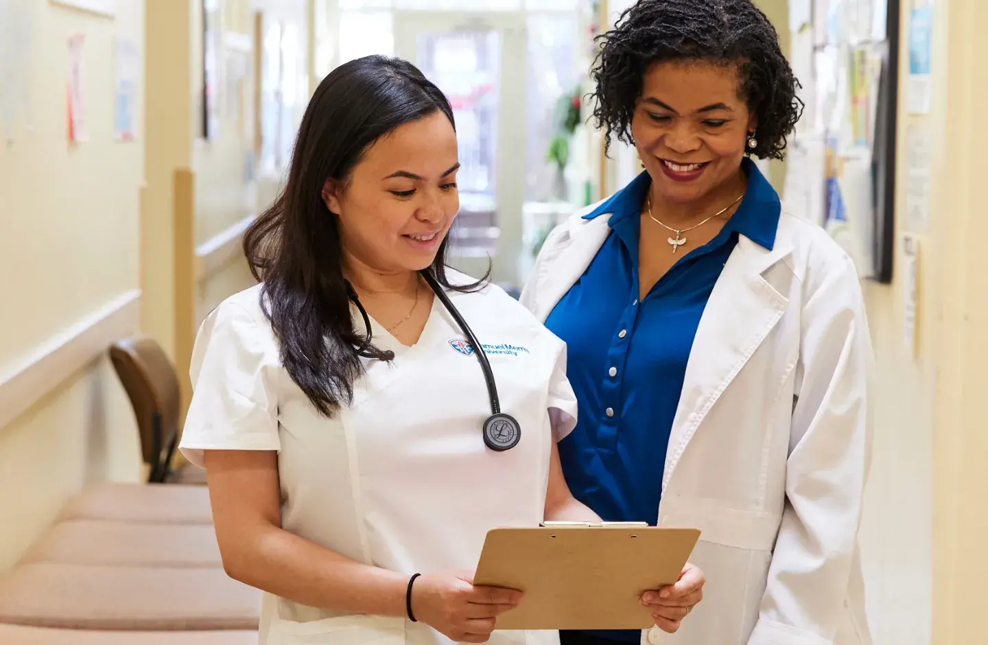 Two nurses in hallway of clinic