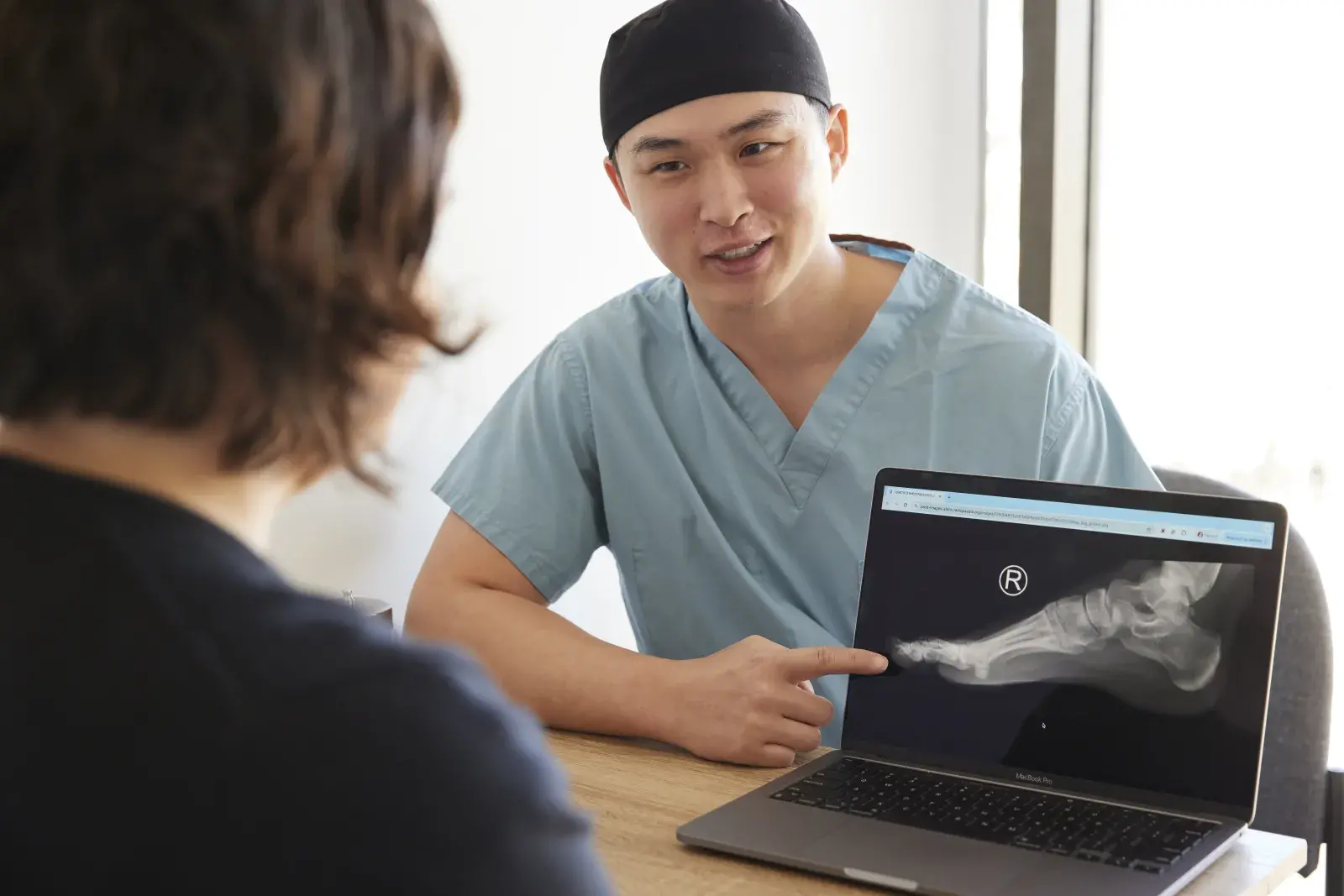 Podiatrist showing an xray on a computer to a patient