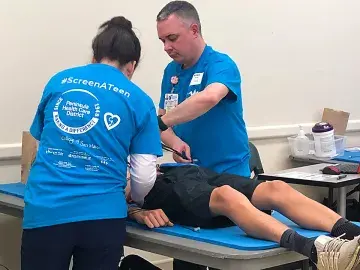 Nursing students screen a teen to ensure proper heart function.