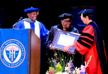 Jovine F. Hankins receiving an honorary doctorate from SMU leadership.