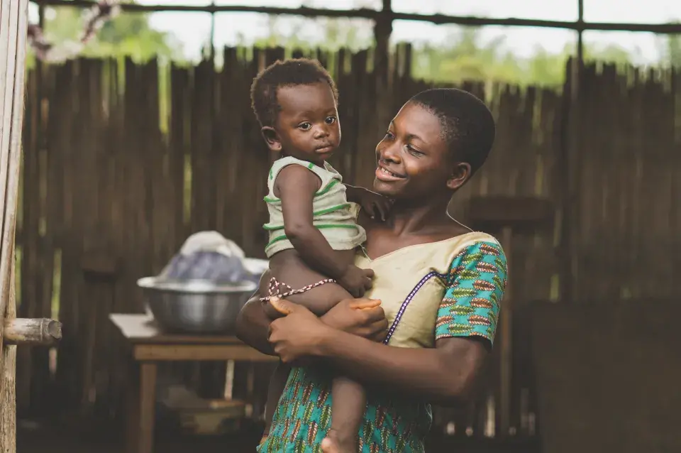 women holding baby