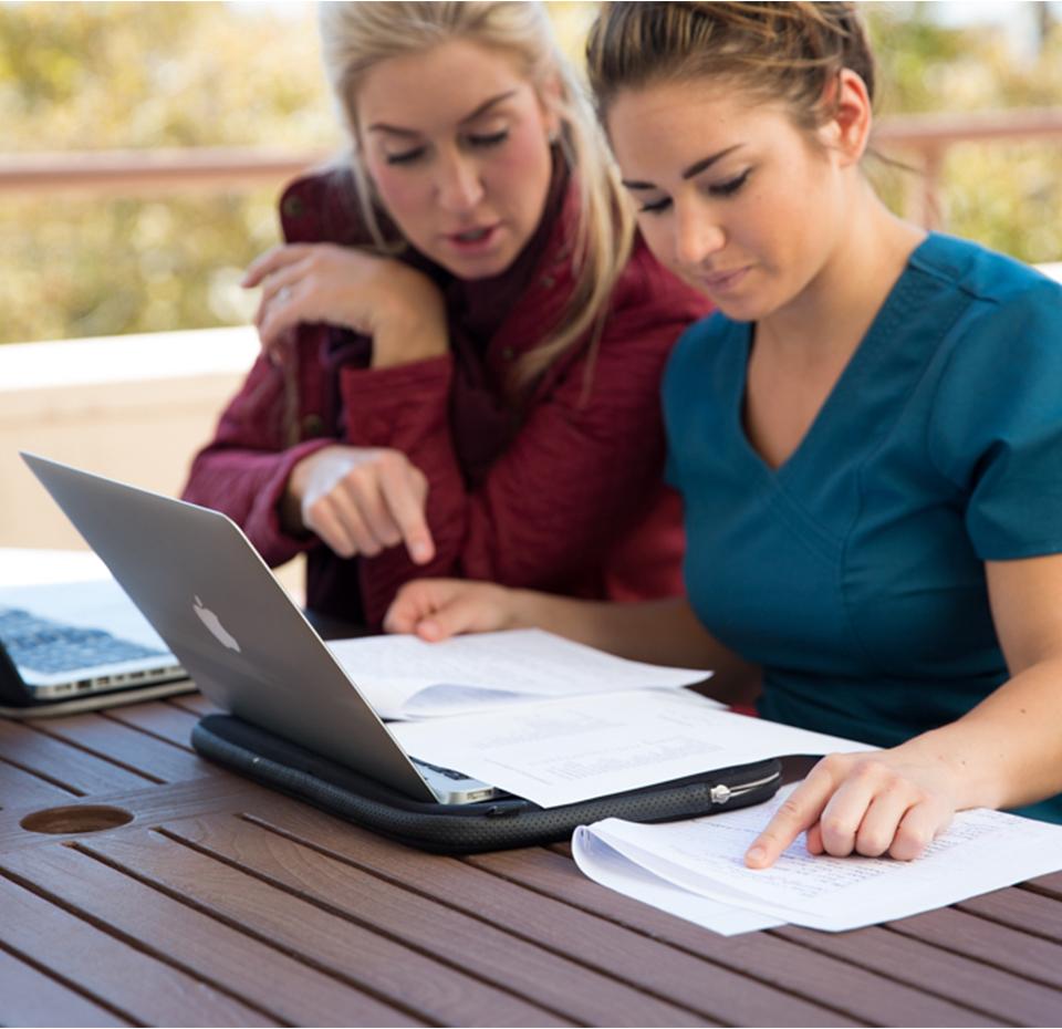 Two female students on laptop