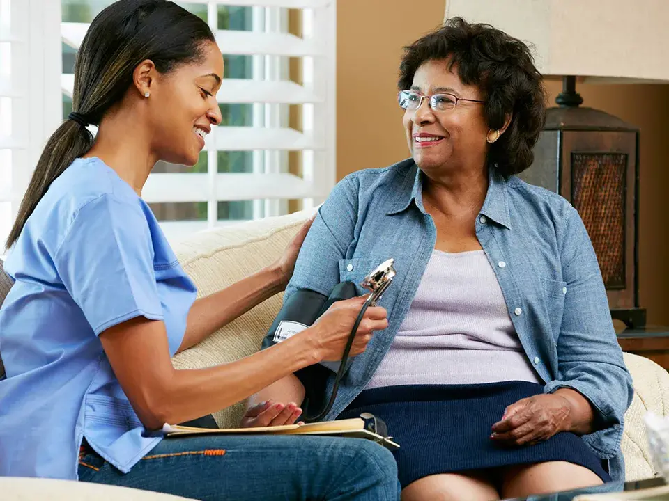 Nurse with older adult patient