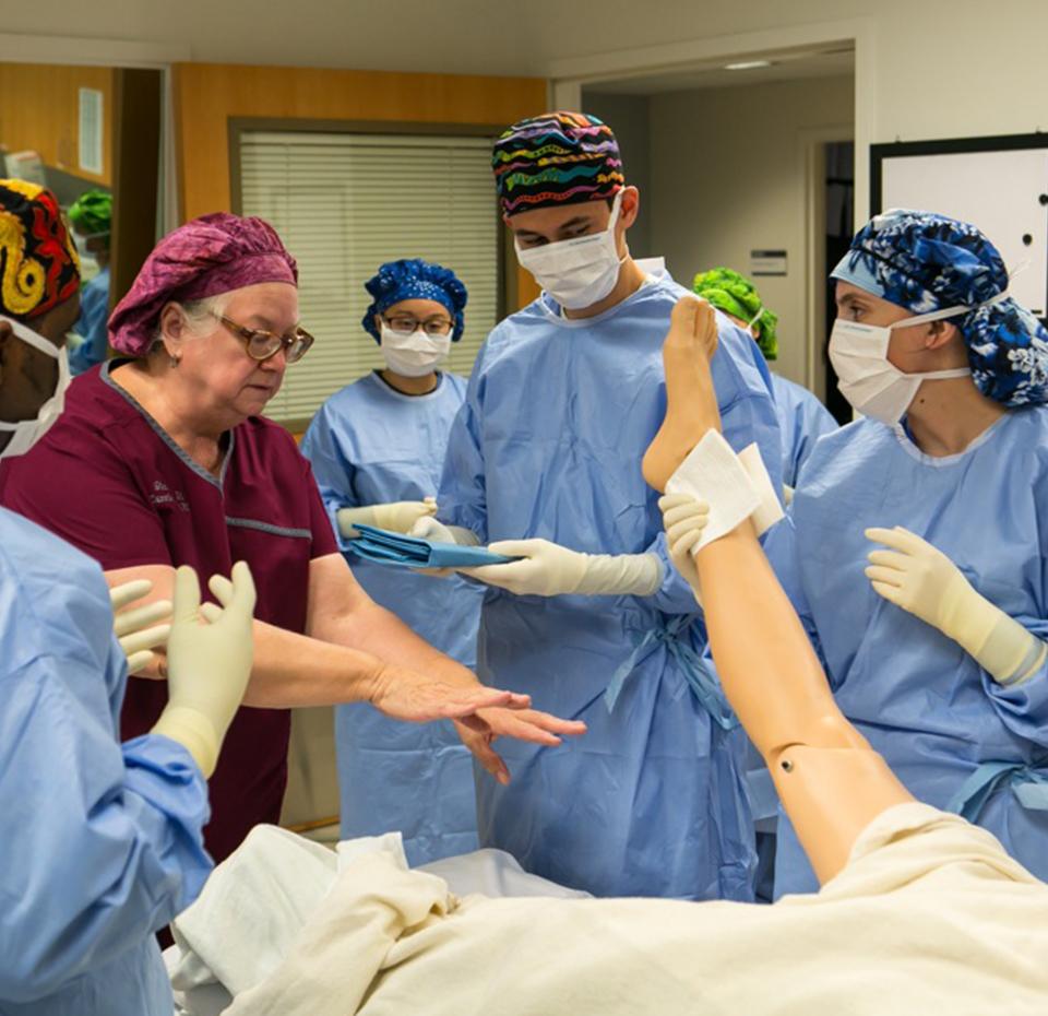 Nurse with students in simulation lab